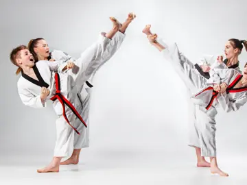 Andy Mole Tae Kwon Do - Tile Image - 4 kids practicing martial arts kicks in the air towards each other