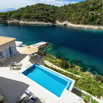 Greek Island Retreats - Hero Image - Image of villa with view over looking coastline