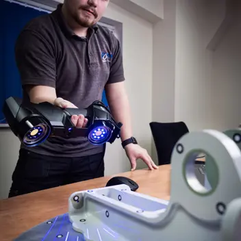 AIM ltd - Tile Image - An employee holding laser scanner scanning a product made by AIM