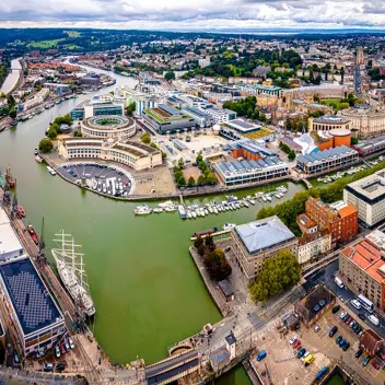 An arial drone image of Bristol harbourside docks with the focal point on Roxburgh Milkins offices