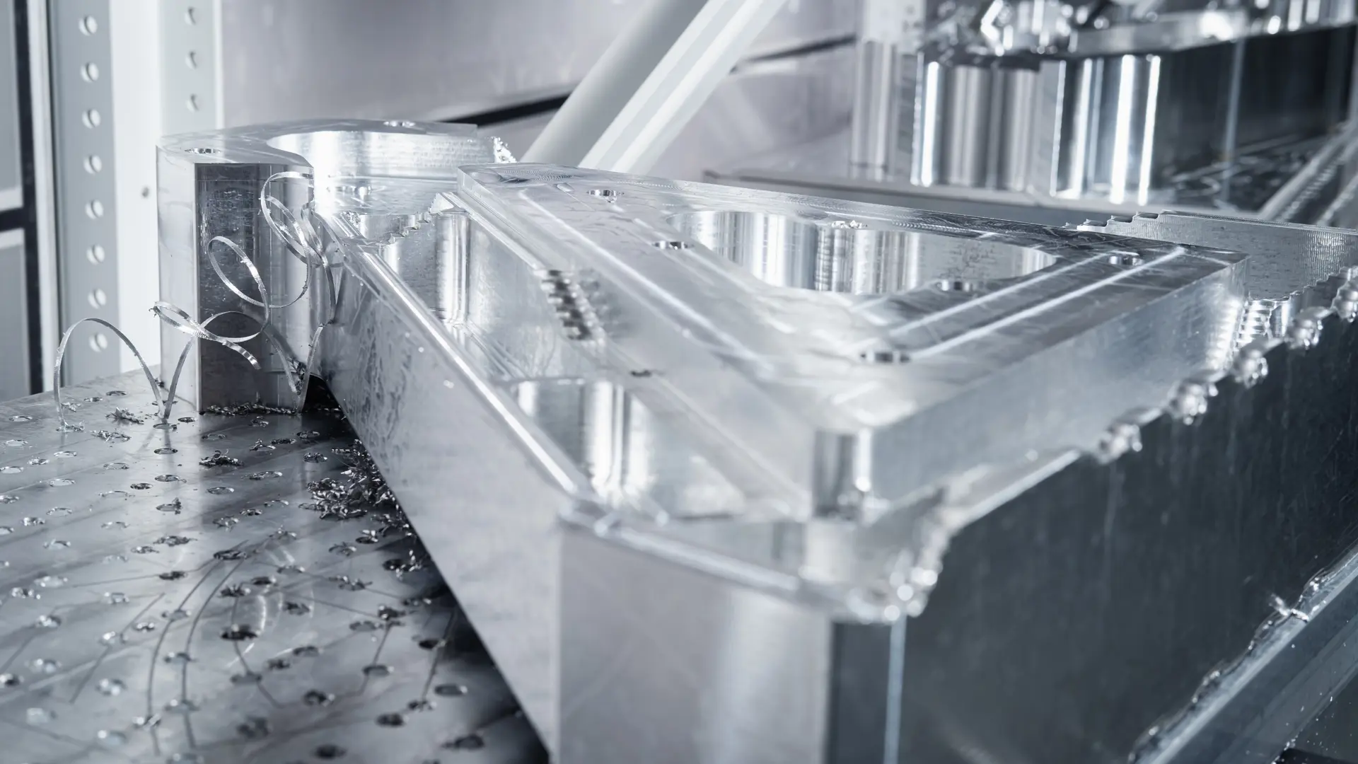 AIM ltd - A close up image of metal swarf being milled off a metallic item