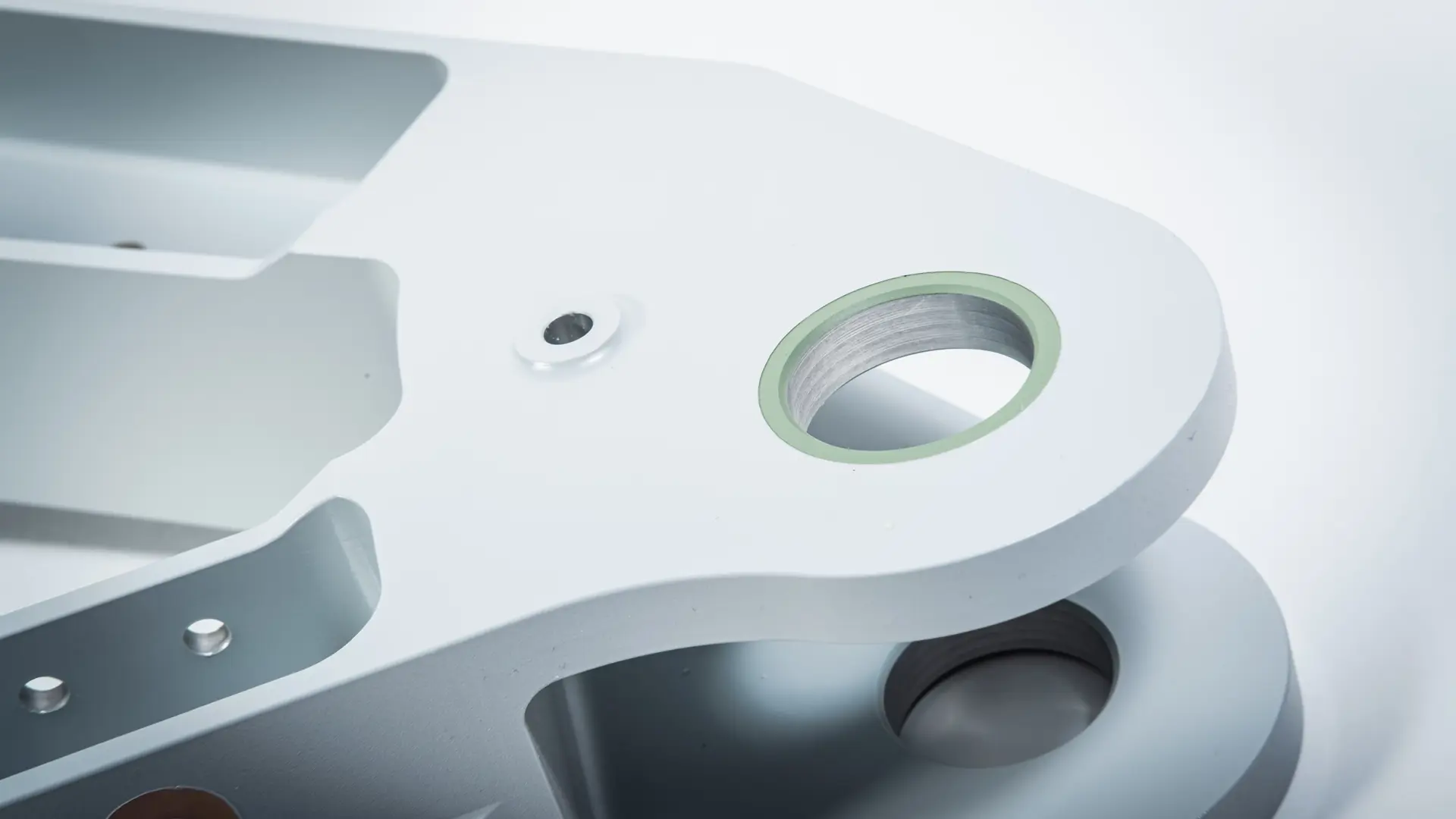 AIM ltd - Close up image of a small metal item with precision drilled holes