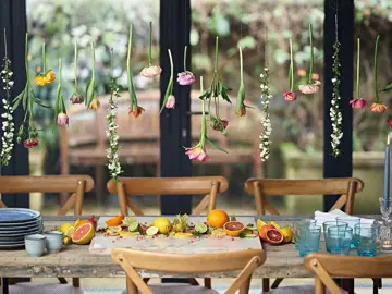 Onkoi - An image of a dressed table with a Flower Curtain And Citrus Fruit getting ready for  a party
